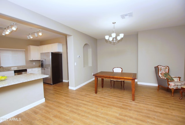 2150 W Alameda Rd Unit 1109, Phoenix, AZ 85085 - kitchen with stainless steel appliances, white cabinets, baseboards, track lighting, and a chandelier