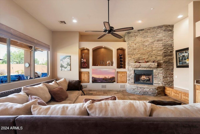 living area featuring a fireplace, visible vents, a ceiling fan, and recessed lighting