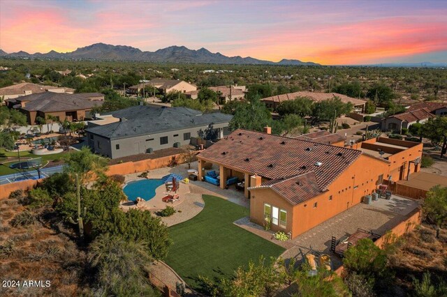 aerial view at dusk featuring a mountain view