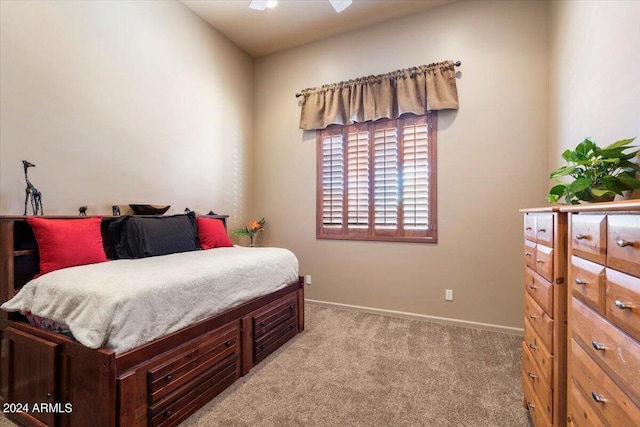 bedroom with light carpet and baseboards