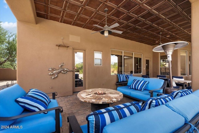 view of patio featuring an outdoor living space with a fire pit and ceiling fan