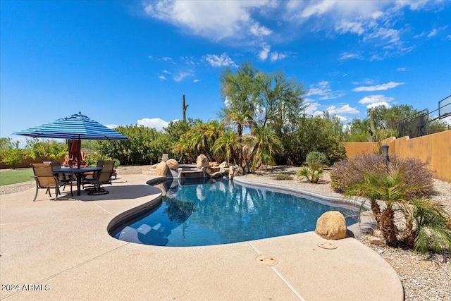 view of pool featuring a fenced in pool, outdoor dining space, a patio area, and fence