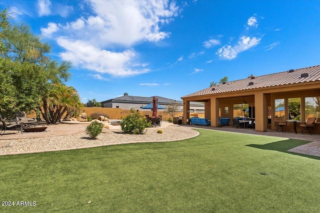 view of yard with a patio area, fence, and a ceiling fan