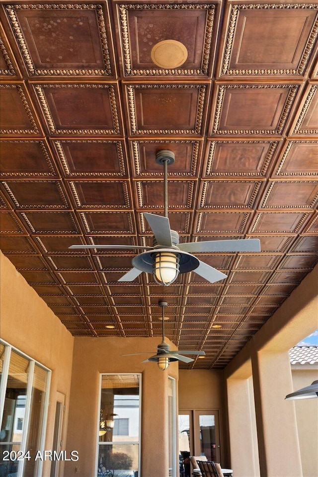 details with a ceiling fan and stucco siding