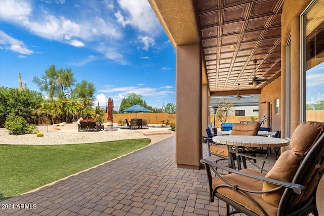 view of patio / terrace with fence, outdoor dining area, and a ceiling fan