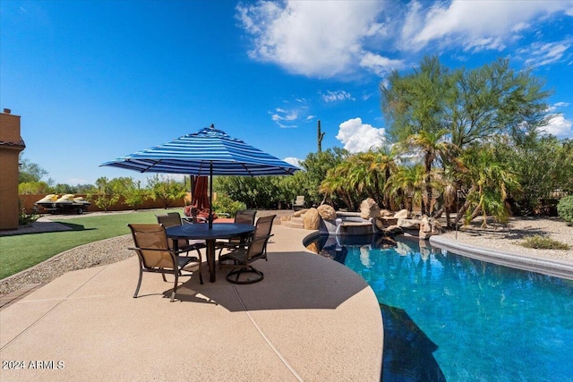 pool with a patio area and outdoor dining space