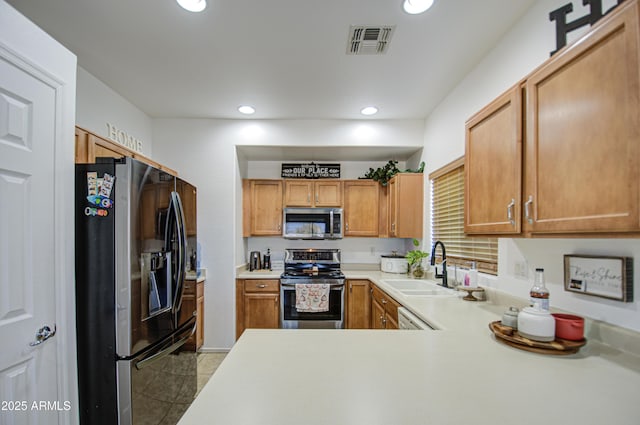 2325 S 88th Dr, Tolleson, AZ 85353 - kitchen with stainless steel appliances, sink, light tile patterned floors, and kitchen peninsula