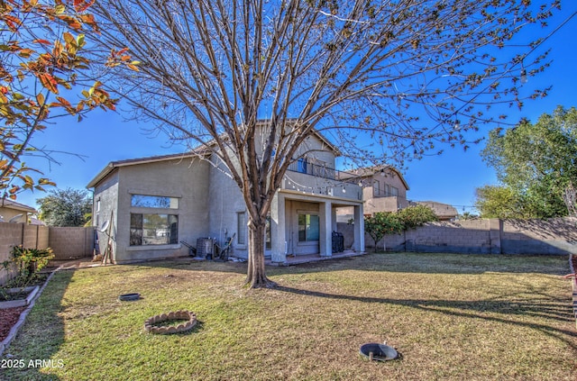 2325 S 88th Dr, Tolleson, AZ 85353 - view of front of home with a balcony, central AC, and a front lawn