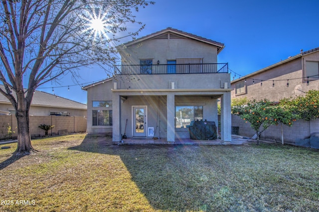 2325 S 88th Dr, Tolleson, AZ 85353 - rear view of house with a balcony, a patio area, and a lawn