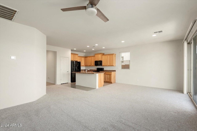 kitchen featuring light carpet, black appliances, and light brown cabinets