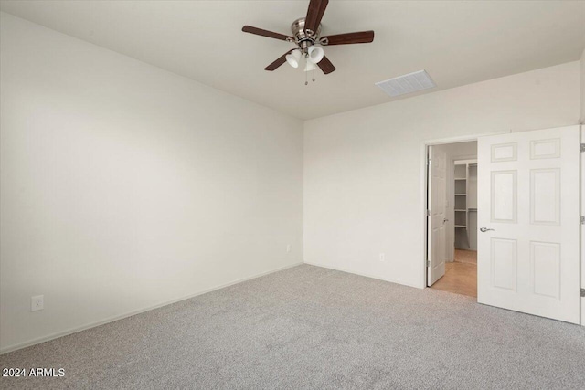 spare room with light carpet and ceiling fan