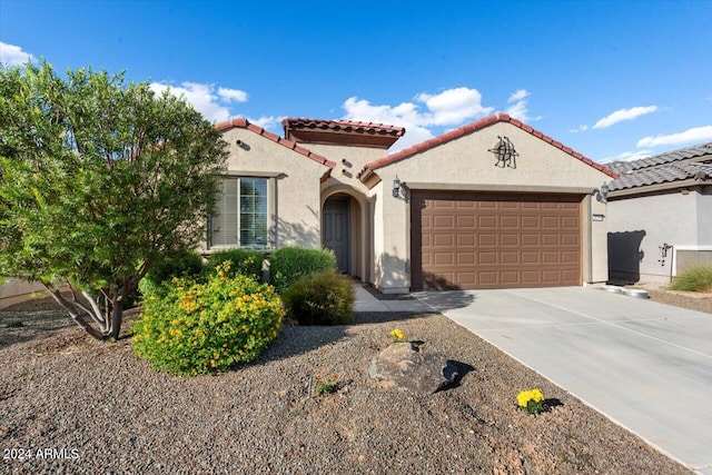 mediterranean / spanish-style home with a garage