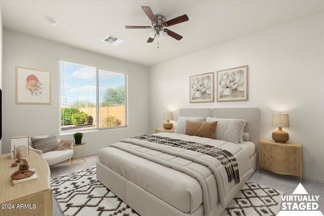 bedroom featuring light carpet and ceiling fan