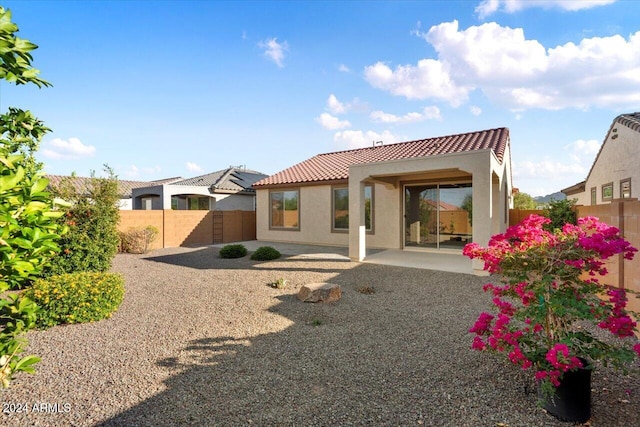 back of property featuring a patio area