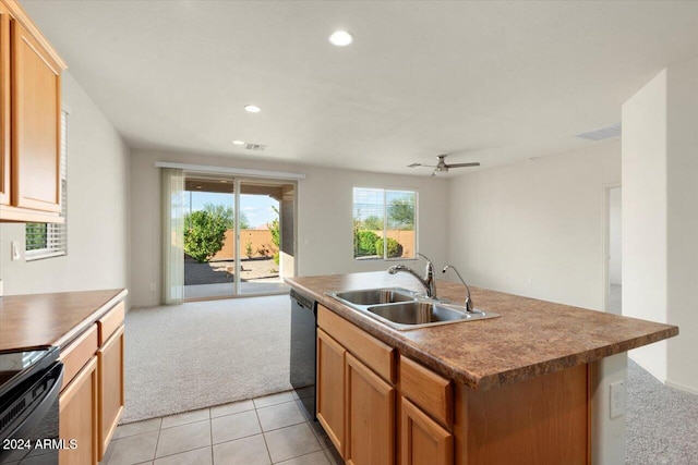 kitchen featuring black appliances, sink, light carpet, ceiling fan, and a center island with sink