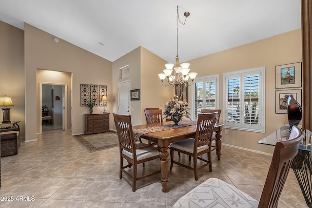 dining space with baseboards, high vaulted ceiling, light tile patterned floors, and an inviting chandelier