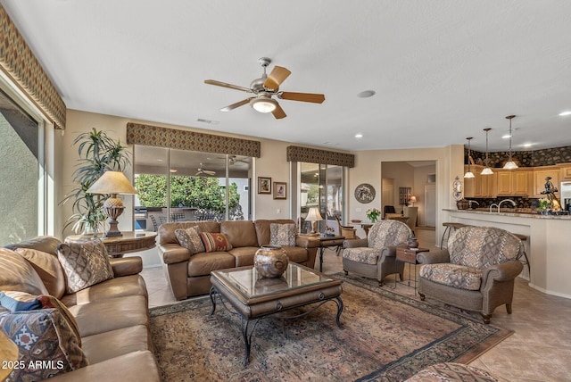 living area featuring recessed lighting, ceiling fan, and light tile patterned floors