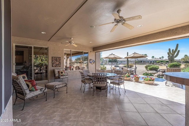 view of patio / terrace featuring a ceiling fan and outdoor dining space