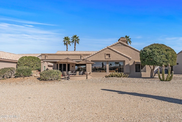 view of front of property with a patio area and stucco siding