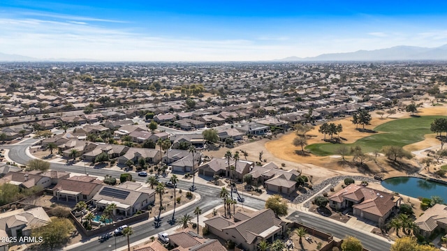 birds eye view of property with view of golf course, a residential view, and a water and mountain view