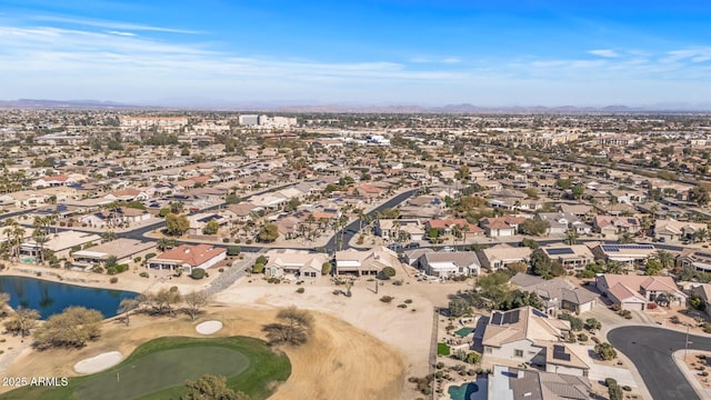 drone / aerial view featuring a water view, a residential view, and golf course view