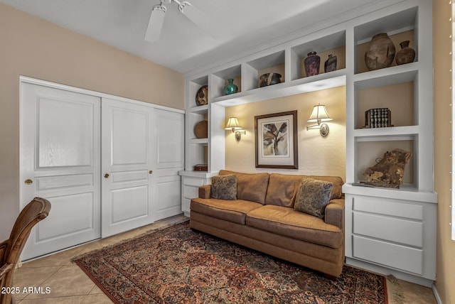 tiled living room featuring built in shelves and a ceiling fan