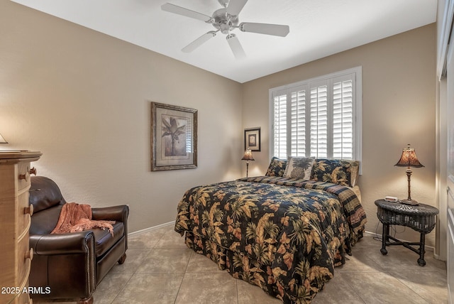 bedroom featuring baseboards, a ceiling fan, and light tile patterned flooring