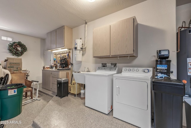 washroom featuring a sink, cabinet space, washing machine and dryer, and a textured ceiling