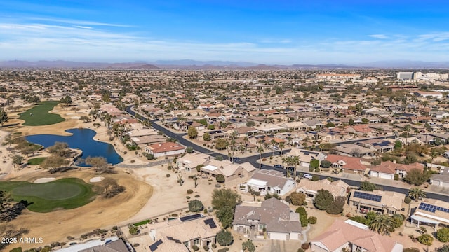 drone / aerial view featuring view of golf course and a residential view