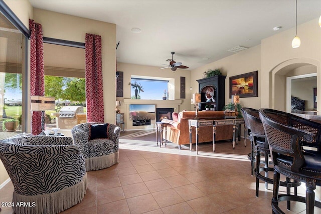 tiled living room featuring a healthy amount of sunlight and ceiling fan