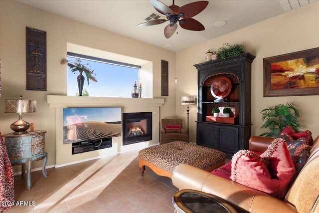 sitting room with ceiling fan and tile patterned flooring