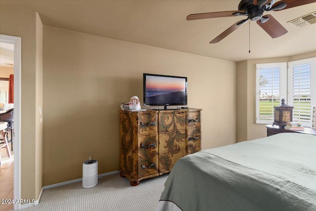 bedroom featuring light colored carpet and ceiling fan