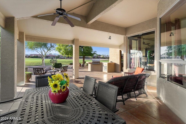 view of patio featuring a grill, an outdoor kitchen, and ceiling fan