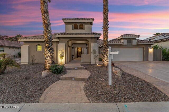 mediterranean / spanish-style home with a garage