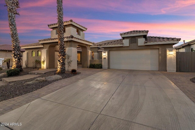 mediterranean / spanish-style house with a garage