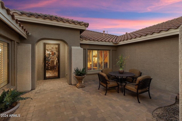 view of patio terrace at dusk