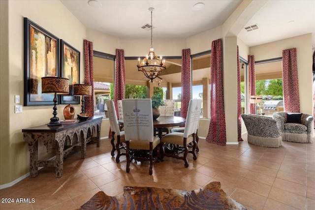 dining room featuring tile patterned floors and an inviting chandelier