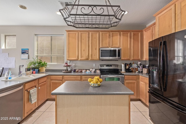 kitchen with appliances with stainless steel finishes, a sink, light tile patterned floors, light brown cabinetry, and recessed lighting