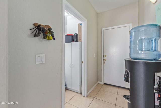 laundry room with light tile patterned floors and baseboards