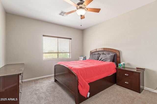 bedroom featuring light colored carpet, baseboards, and a ceiling fan