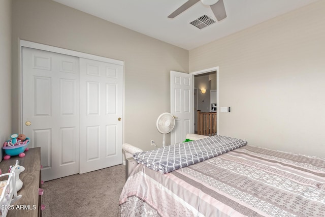 carpeted bedroom featuring a closet and a ceiling fan