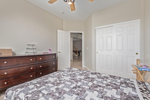 tiled bedroom featuring a closet and ceiling fan