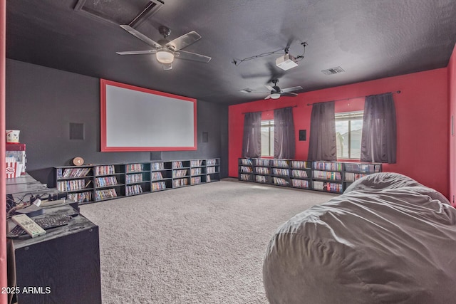 home theater featuring ceiling fan and carpet