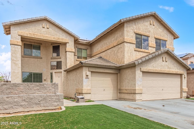 view of front of home featuring stucco siding, driveway, a garage, and a tiled roof