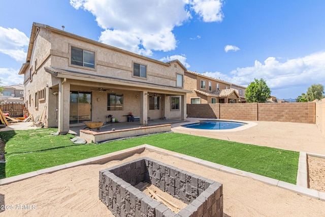 back of house featuring a fire pit, a patio, ceiling fan, and stucco siding