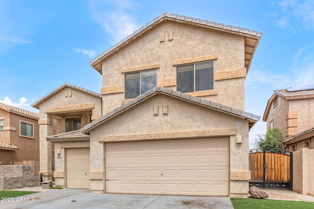 traditional-style home featuring driveway, stucco siding, a gate, and a tiled roof
