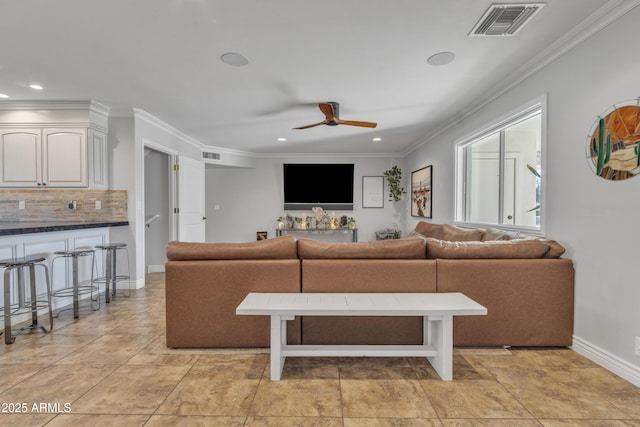 living room with ceiling fan, crown molding, and light tile patterned floors