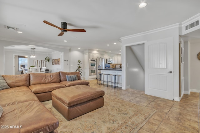 living room with ceiling fan, light tile patterned floors, and ornamental molding