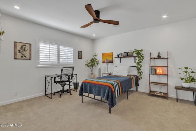 bedroom with ceiling fan and light colored carpet