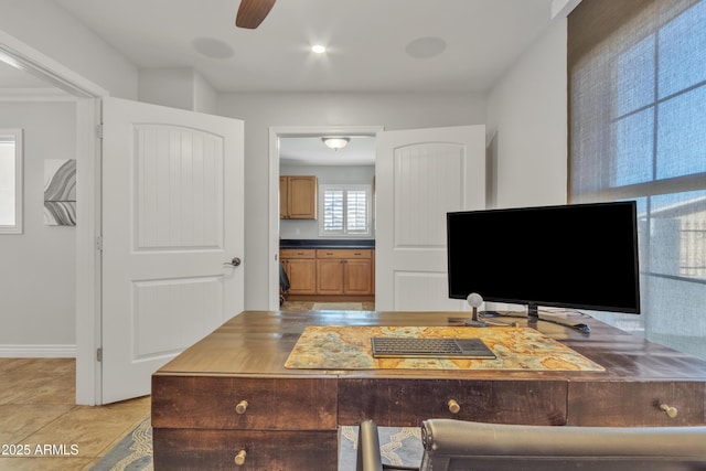 home office featuring ceiling fan, ornamental molding, and light tile patterned floors